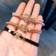 Golden chain hair tie