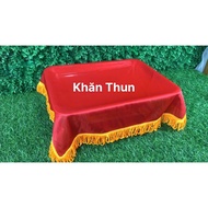 Cloth scarf with yellow tassels covers the stage award tray