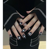 Nailbox designed with long black painted nails and a super pretty y2k style star look