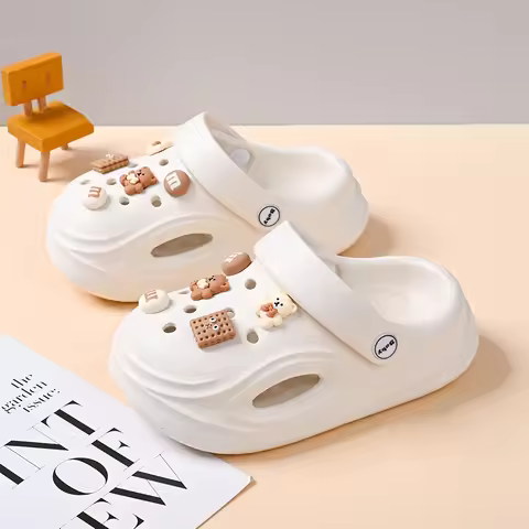 A pair of children's summer slippers with soft soles, comfortable to wear and featuring a hole desig