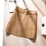 Women's mini synthetic leather skirt above the knee