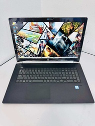 HP laptop with gaming wallpaper display and full keyboard layout.