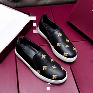 Black Slipon with sharp embroidery - close-up photo at the shop