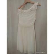 Beige color off shoulder dress.