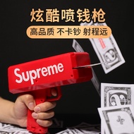 Red money spitting toy gun party toy