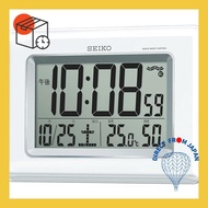 Seiko clock is wall and desk use, with digital display of time, calendar, temperature, and humidity in white pearl color. Model SQ424W.