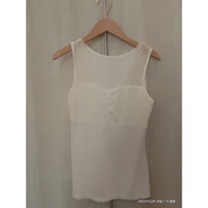 Beige color lace singlet.