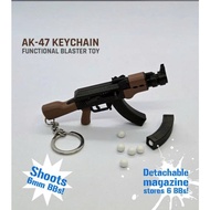 XO AK47 gun model keychain made from ABS plastic and has spring-operated mechanism