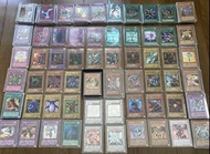 遊戲王卡片，總共超過 300 張卡片，包括較老的卡片和閃卡，例如卡通黑魔導女孩、超稀有卡、雷霆之主哈蒙以及浮雕卡，來自早期和第二系列。