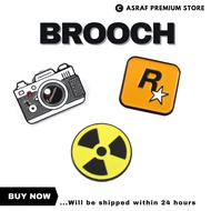 [Post 24H] Creative R Star Biochemical Radiation Camera Shape Brooch Metal Badge Backpack Clothes De