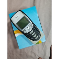 Nokia 8310 mobile phone with silver and black design on blue box. Numeric keypad, small screen, and 