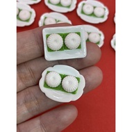 Handmade Miniature Tutu Kueh, Putu piring or kuih tutu, round-shaped, traditional steamed rice flour kue, clay