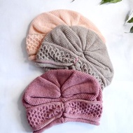 Knitted hat with drapery. Stylish women's hat.