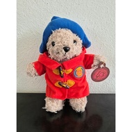 Paddington bear plushie in a red coat with a blue hat
