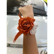 Wrist corsage for bridesmaid orange