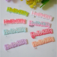 Hello Kitty letter charms in various colors used to decorate phone cases, Jibbitz stickers, hairpins