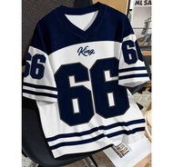 Black and white 49ers jerseys with number 99 for couples. Casual streetwear. Urban setting.
