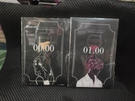 Paket novel 00:00 dan 01:00 dengan sampul hitam dan ilustrasi profil karakter.