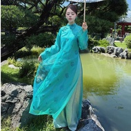 Nguyet Linh innovative ao dai, loose shape, embroidered with flowers, flared sleeves and bow at the 