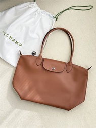 Longchamp cognac PU leather crossbody bag set with 4 bags and carrying case.