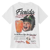 Genuine NELLYHEYBIG shirt with short sleeves, baby pattern with Florida orange juice cup.