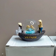Boat-shaped snow globe model of Vietnamese landmarks