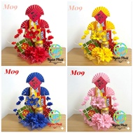 Tower cake model M09 decorated CNY in rose gold, red, green, and blue tones with the meaning of fort